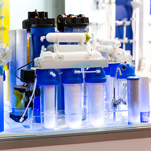 Water purifier installation Dubai - Aqua Touch technician installing RO system in home